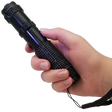 A hand holding a 75M JOLT RhineStun Gun Rechargeable Flashlight