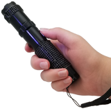 A hand holding a 75M JOLT RhineStun Gun Rechargeable Flashlight