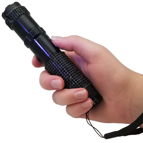 A hand holding a 75M JOLT RhineStun Gun Rechargeable Flashlight