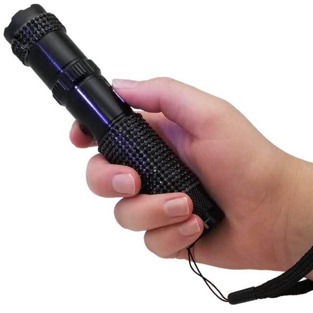 A hand holding a 75M JOLT RhineStun Gun Rechargeable Flashlight