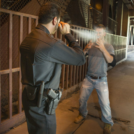 A man using the asp metro defender keychain to another man
