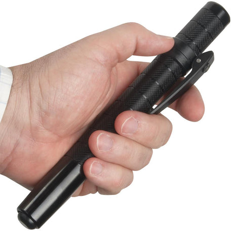 A hand holding a retracted ASP Protector Friction Loc Expandable Clip-On Baton