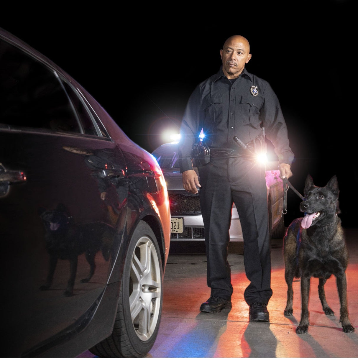 A K9 and a police in full gear including ASP Raptor Flashlight Tactical Light Case Holster clipped in his belt