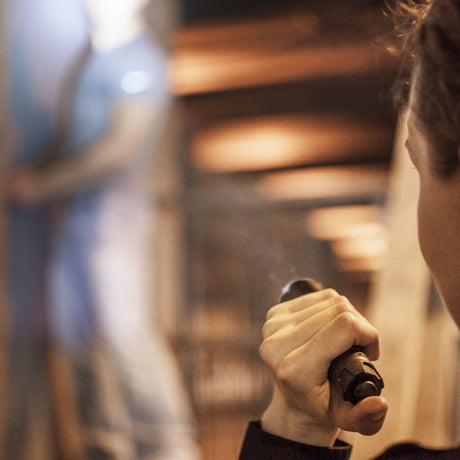 A police woman using ASP Tungsten DF Rechargeable LED Flashlight 430 Lm at night