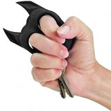 A hand wearing a black Brutus Bulldog Self-Defense Keychain Knuckle Weapon with keys