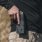 Hand drawing a black TASER Pulse stun gun from Black Blade-Tech Kydex holster