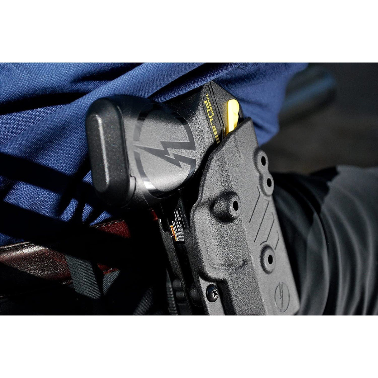 Close-up of a Black Blade-Tech Kydex holster with TASER Pulse stun gun on a belt