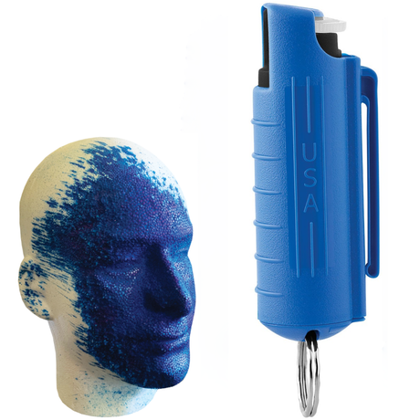 A blue keychain pepper spray alongside a mannequin head with blue dye markings.