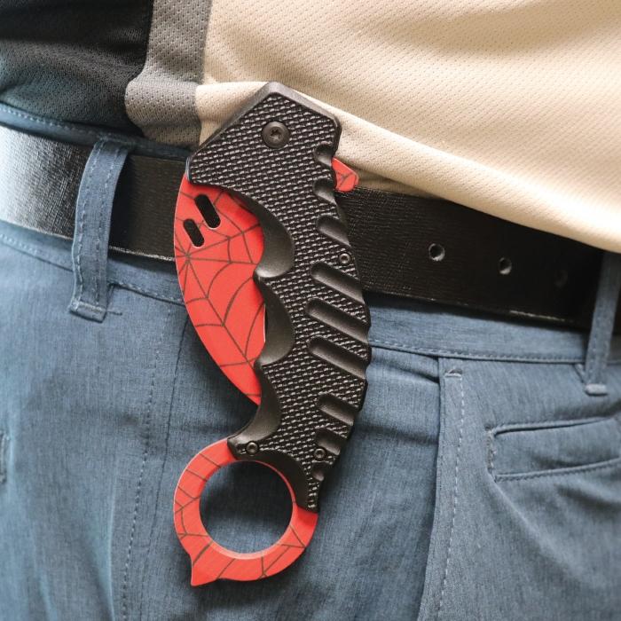 1.5 inch ElitEdge Steel Karambit Folding Pocket Knife clipped to a black belt