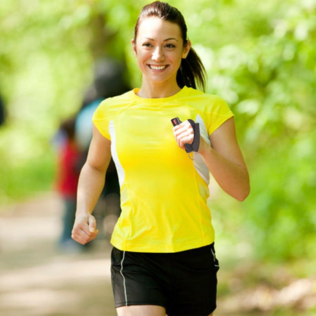 A woman jogging while holding a Black Eliminator 3-in-1 Hard Case Jogger Pepper Spray