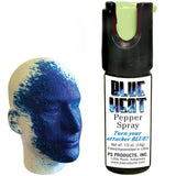 A canister of Eliminator Blue Heat Pepper Spray alongside a mannequin head with blue dye markings.