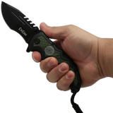 hand holding an open Black 3.5" folding tactical knife by Elite Edge with an army green camouflage handle with paracord