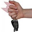 A hand holding a Pink My Kitty Plastic Self-Defense Keychain Weapon with keys attached