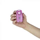 A hand holding a pink Streetwise 120dB Keychain Panic Alarm LED Light