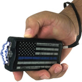 A hand holding a Police Force Tactical Blue Line Stun Gun