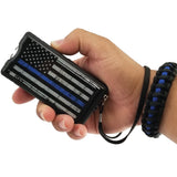 A hand wearing a paracord survival bracelet while holding a Police Force Tactical Blue Line Stun Gun
