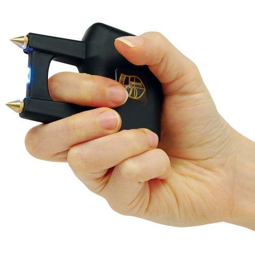 Hand gripping a black Safety Tech Spike Knuckle Rechargeable Stun Gun