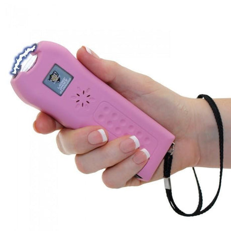 Streetwise™ Ladies' Choice LED Stun Gun Alarm 21M in pink color strapped in a hand