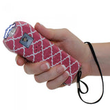 a hand holding a pink and white patterned Streetwise™ Ladies' Choice LED Stun Gun Alarm 21M.