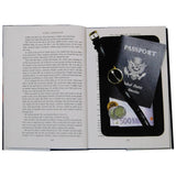 An open hardbound book, revealing a hidden black diversion safe inside that contains important belongings