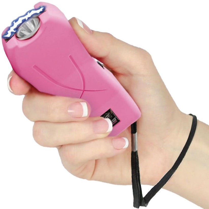 A hand holding a Pink Mini Rechargeable Stun Gun with wrist strap from Streetwise