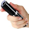 Black Streetwise™ Perfume Protector Disguised Rechargeable Stun Gun 17M disguised as a perfume or lipstick tube held in hand