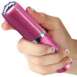 A hand holding a pink Streetwise Perfume Protector Disguised Rechargeable Stun Gun 17M