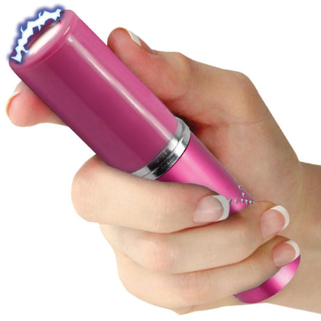 A hand holding a pink Streetwise Perfume Protector Disguised Rechargeable Stun Gun 17M