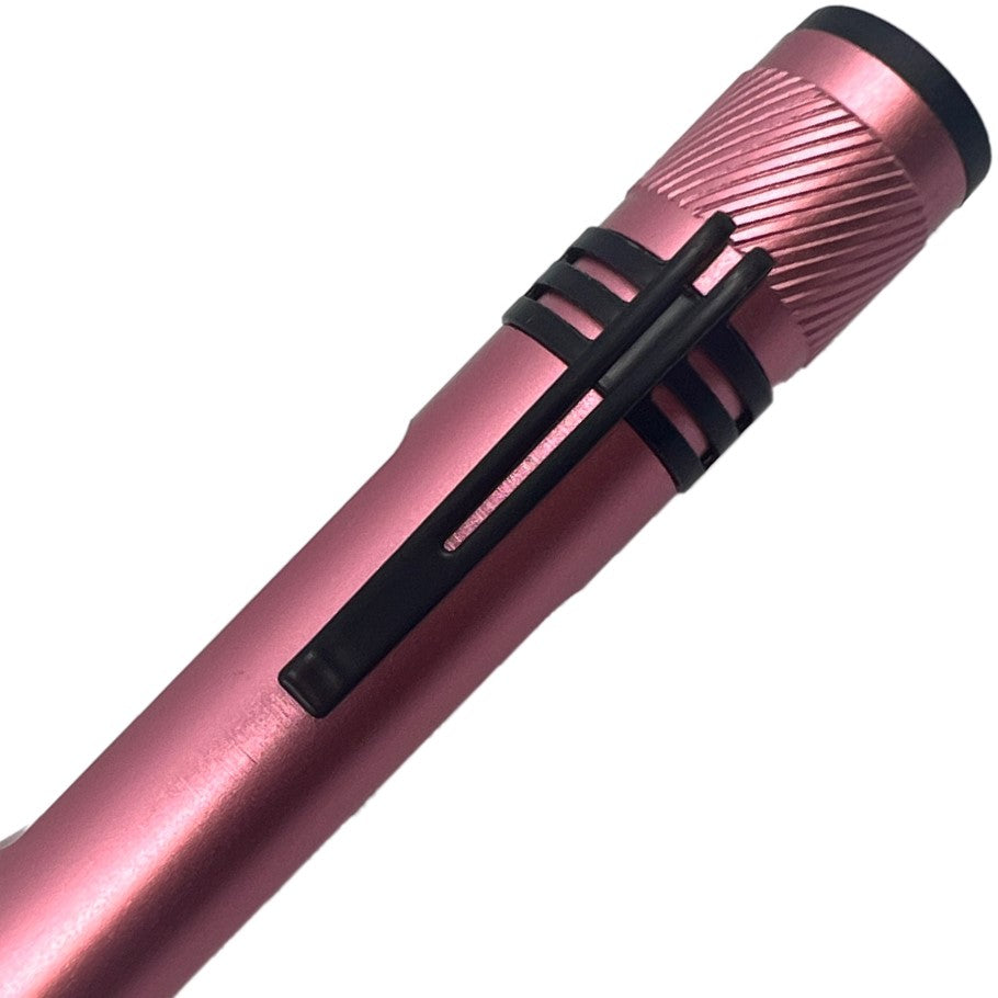 A close up view of a pink streetwise streetlight LED flashlight showcasing its built-in pocket clip.