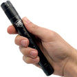 A hand holding a black Streetwise Streetlight LED Flashlight Stun Gun 83M.
