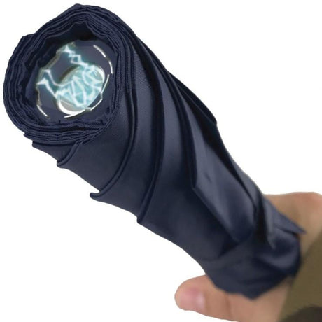a hand holding a Streetwise™ Stunbrella Stun Gun Flashlight 32M Blue up close to its stun metal prongs and LED flashlight