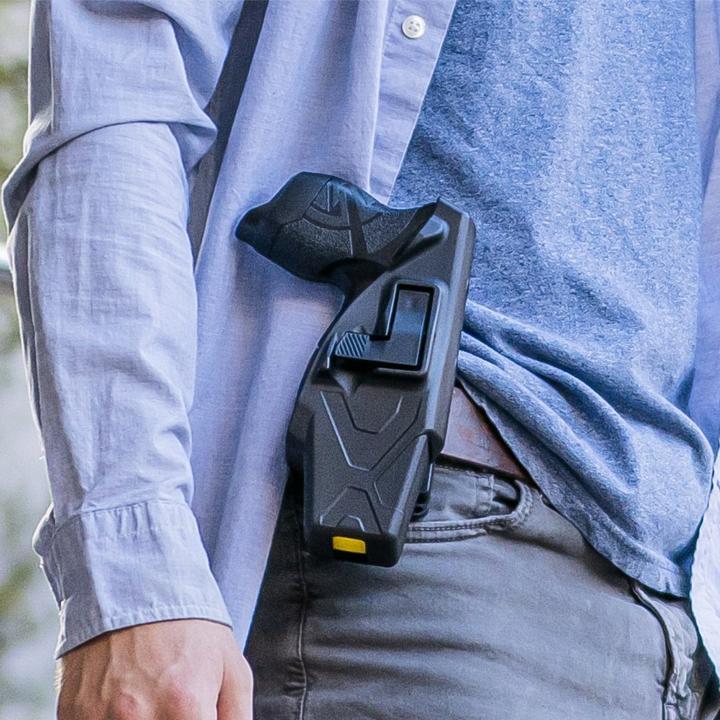 a TASER X1 Reloadable Shooting Stun Gun in a black holster, attached to the waistband