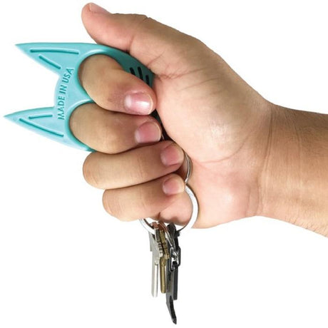 A hand holding a Teal My Kitty Plastic Self-Defense Keychain Weapon with keys attached