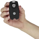 a hand holding a The Protector Self-Defense Alarm black