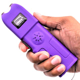 a hand holding a purple Tiger-USA Xtreme Sanctuary LED Alarm Stun Gun 