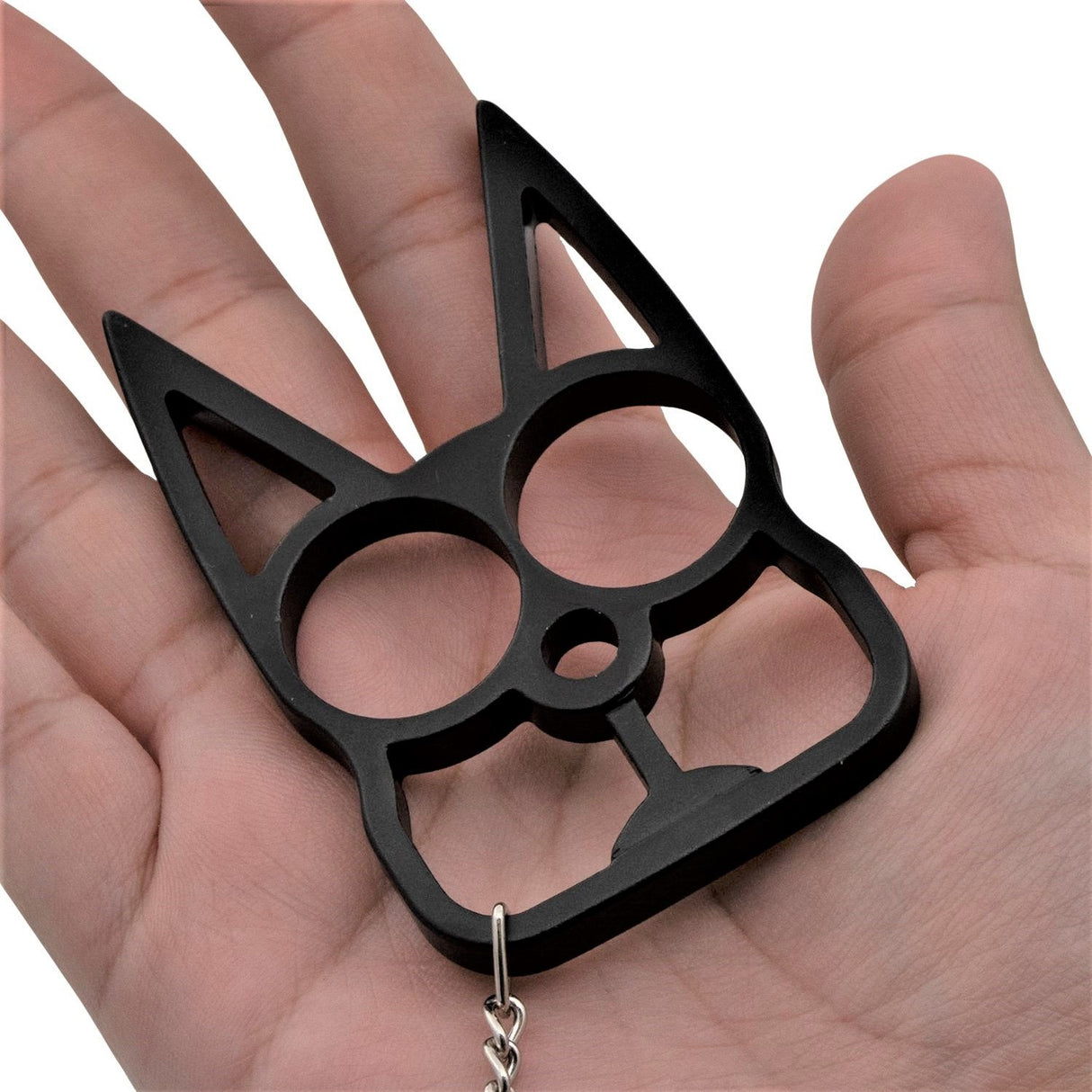 a black WeaponTek Cat Keychain Self-Defense Metal Knuckle Weapon placed on a hand