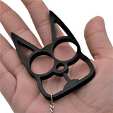 a black WeaponTek Cat Keychain Self-Defense Metal Knuckle Weapon placed on a hand