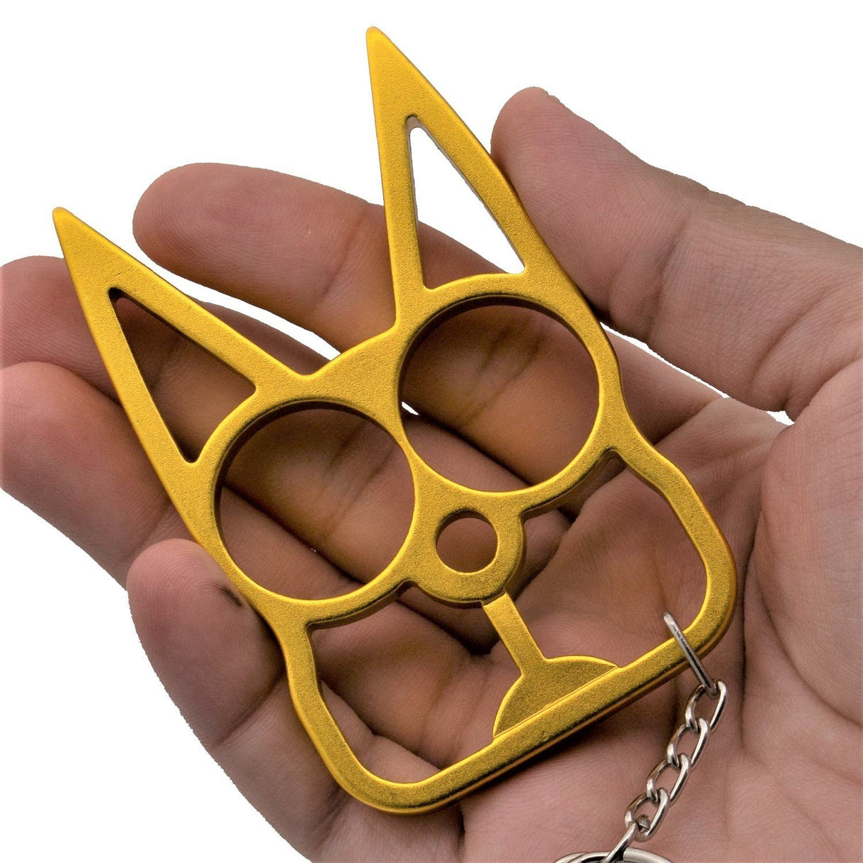 a gold WeaponTek™ Cat Keychain Self-Defense Metal Knuckle Weapon placed on hand