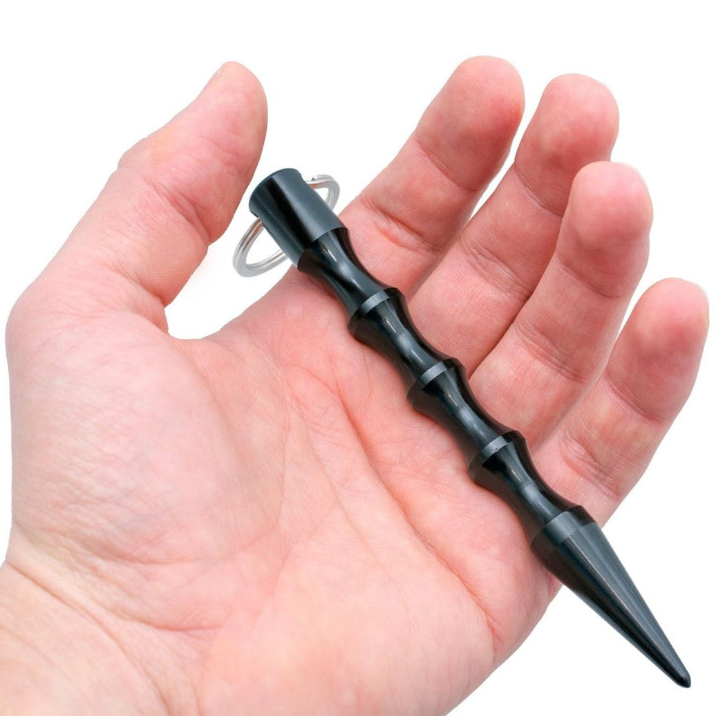a hand holding a WeaponTek Tactical Pointed Tip Grooved Grip Kubotan 5.5"