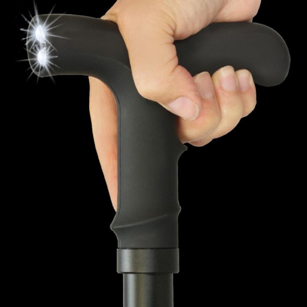a hand holding a ZAP™ Covert Rechargeable LED Stun Gun Walking Cane with its LED light on